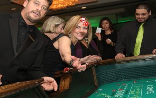 A group of people at a casino table.