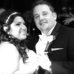 A black and white photo of a bride and groom dancing.