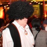 A man wearing an afro wig at a party.