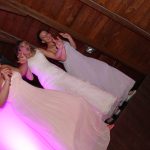 Three bridesmaids dancing on the dance floor.