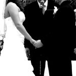 Black and white photo of a bride and groom exchanging vows.