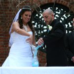 A bride and groom cutting a cake.