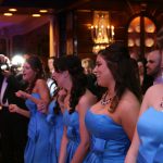 A group of bridesmaids dancing at a wedding reception.
