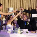 A bride and groom toasting champagne at a wedding reception.