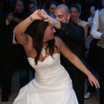 A bride and groom dancing on the dance floor.