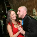 A man and woman dancing at a wedding reception.