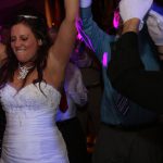 A bride and groom dancing on the dance floor at a wedding.