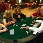 A group of people at a poker table.