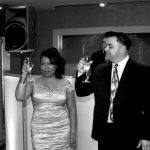 Black and white photo of a man and woman holding wine glasses.