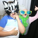 Two children posing for a photo in a photo booth.