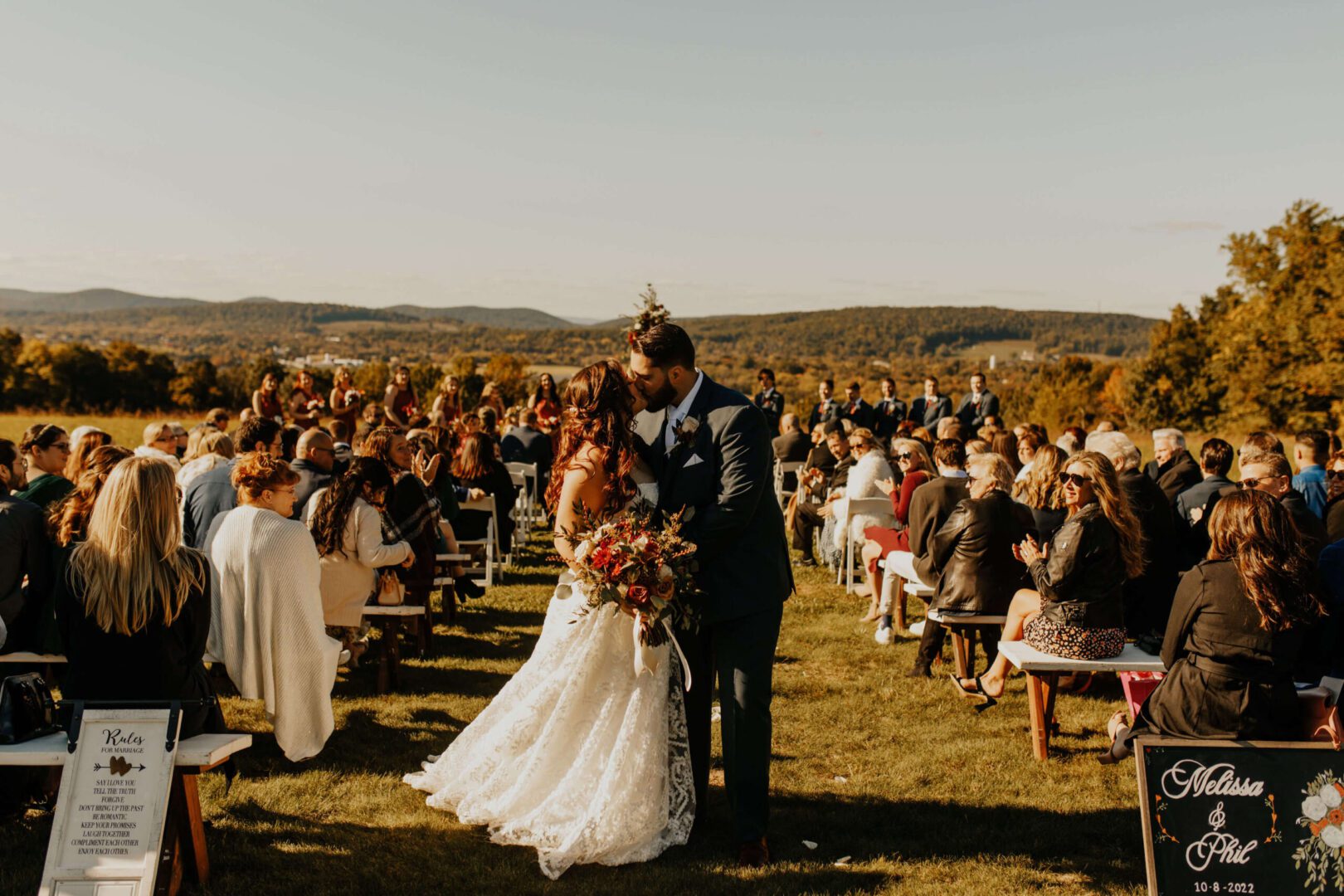 Bride and groom kissing at wedding ceremony.