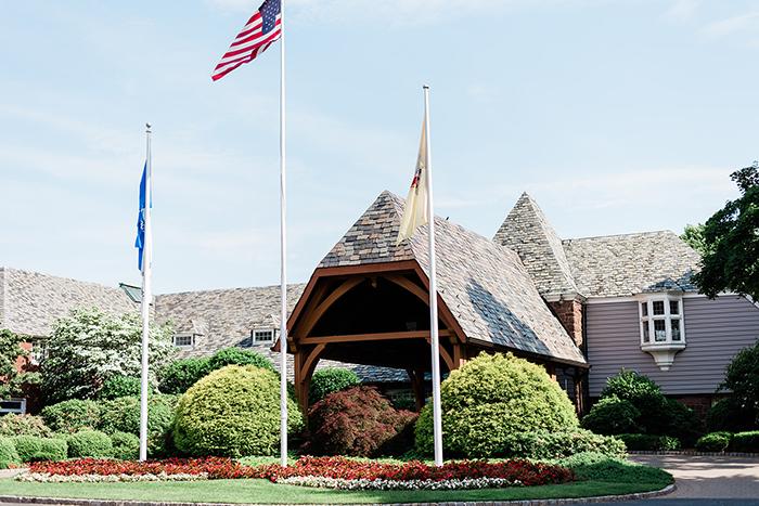 Building entrance with American and state flags.